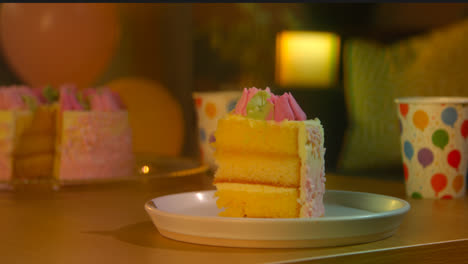 Slice-Of-Party-Celebration-Cake-For-Birthday-Decorated-With-Icing-On-Table-At-Home-8